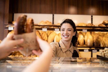 Beautiful,Smiling,Bakery,Worker,Selling,Pastry,To,The,Customer,In